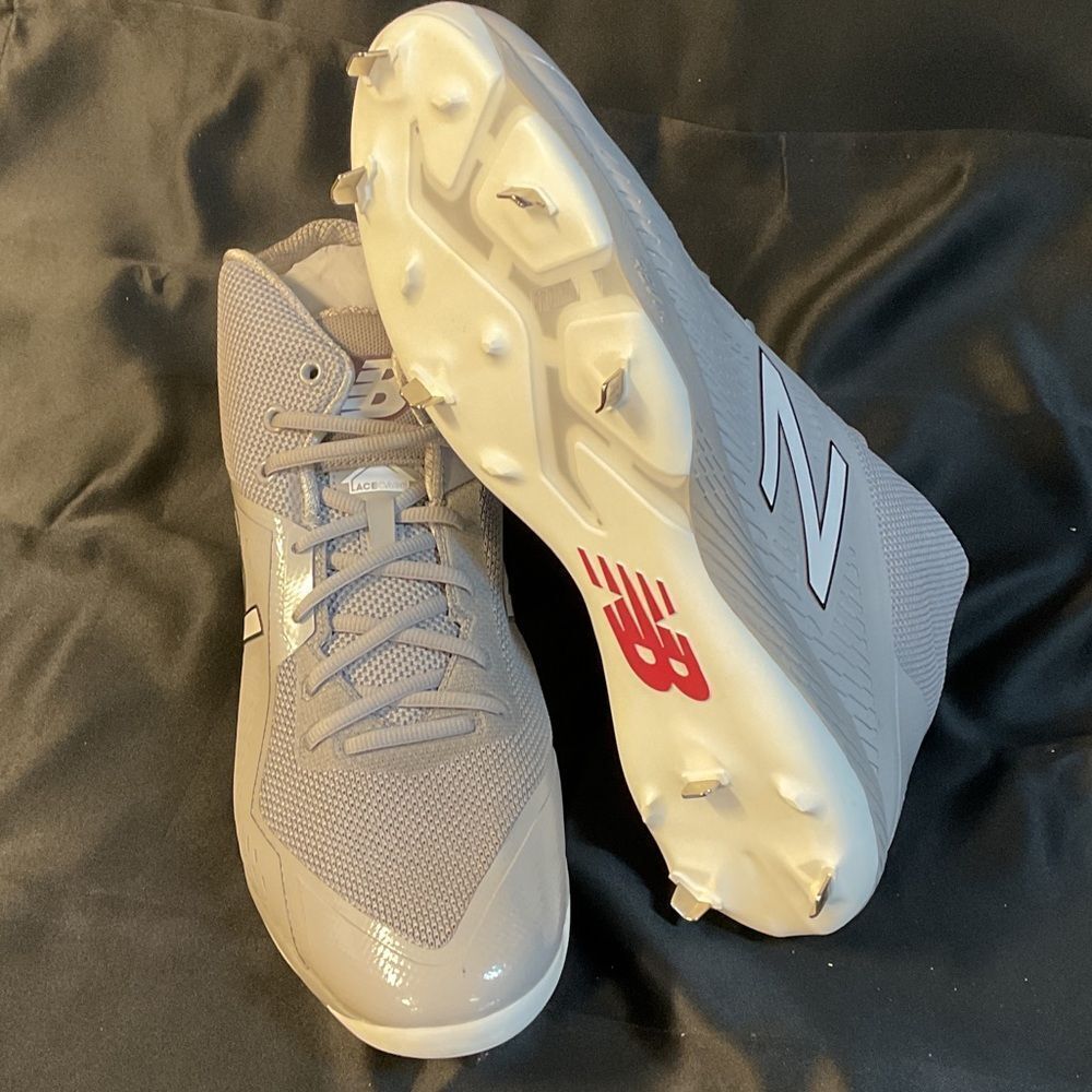 New Balance Gray and White Men's Athletic Cleats. 
16 2E Wide